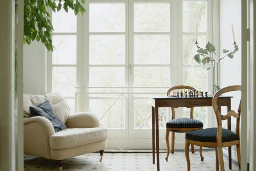 Modern Bedroom with Black and white 3d rendering Image.There are a black wall,floor,furniture and white shelf,carpet There are large windows looking out to metropolis view